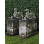 A PAIR OF SCULPTED LIMESTONE MODELS OF RECUMBENT HOUNDS, SECOND HALF 20TH CENTURY