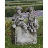A PAIR OF COMPOSTION STONE SITTING PUTTI'S, 20TH CENTURY (NO BASE)