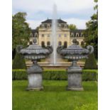 A PAIR OF CARVED LIMESTONE GARDEN TWIN HANDLED URNS WITH COVERS SECOND HALF 20TH CENTURY