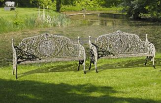 A PAIR OF CONTINENTAL CAST IRON GARDEN BENCHES IN 19TH CENTURY STYLE, MID 20TH CENTURY, AFTER THE ‘M