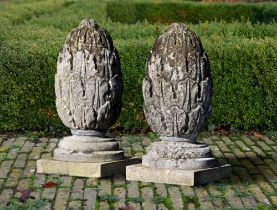 A PAIR OF CARVED LIMESTONE PIER FINIALS 19TH CENTURY, ON A LATER PLINTH