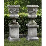 TWO SIMILAR CARVED LIMESTONE GARDEN URNS, LATE 19TH OR EARLY 20TH CENTURY