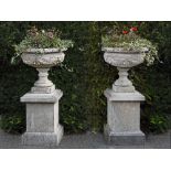 A PAIR OF COMPOSITION STONE PEDESTAL URNS ON PLINTHS, LATE 20TH CENTURY