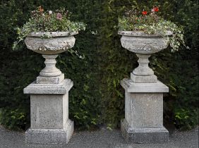 A PAIR OF COMPOSITION STONE PEDESTAL URNS ON PLINTHS, LATE 20TH CENTURY