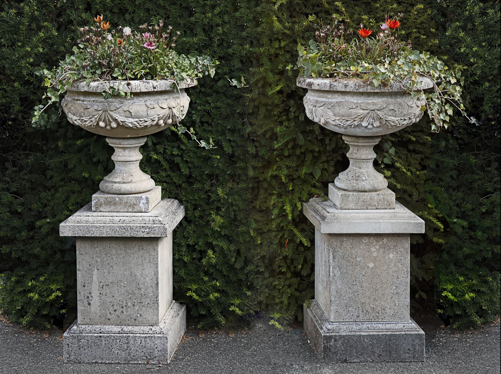 A PAIR OF COMPOSITION STONE PEDESTAL URNS ON PLINTHS, LATE 20TH CENTURY