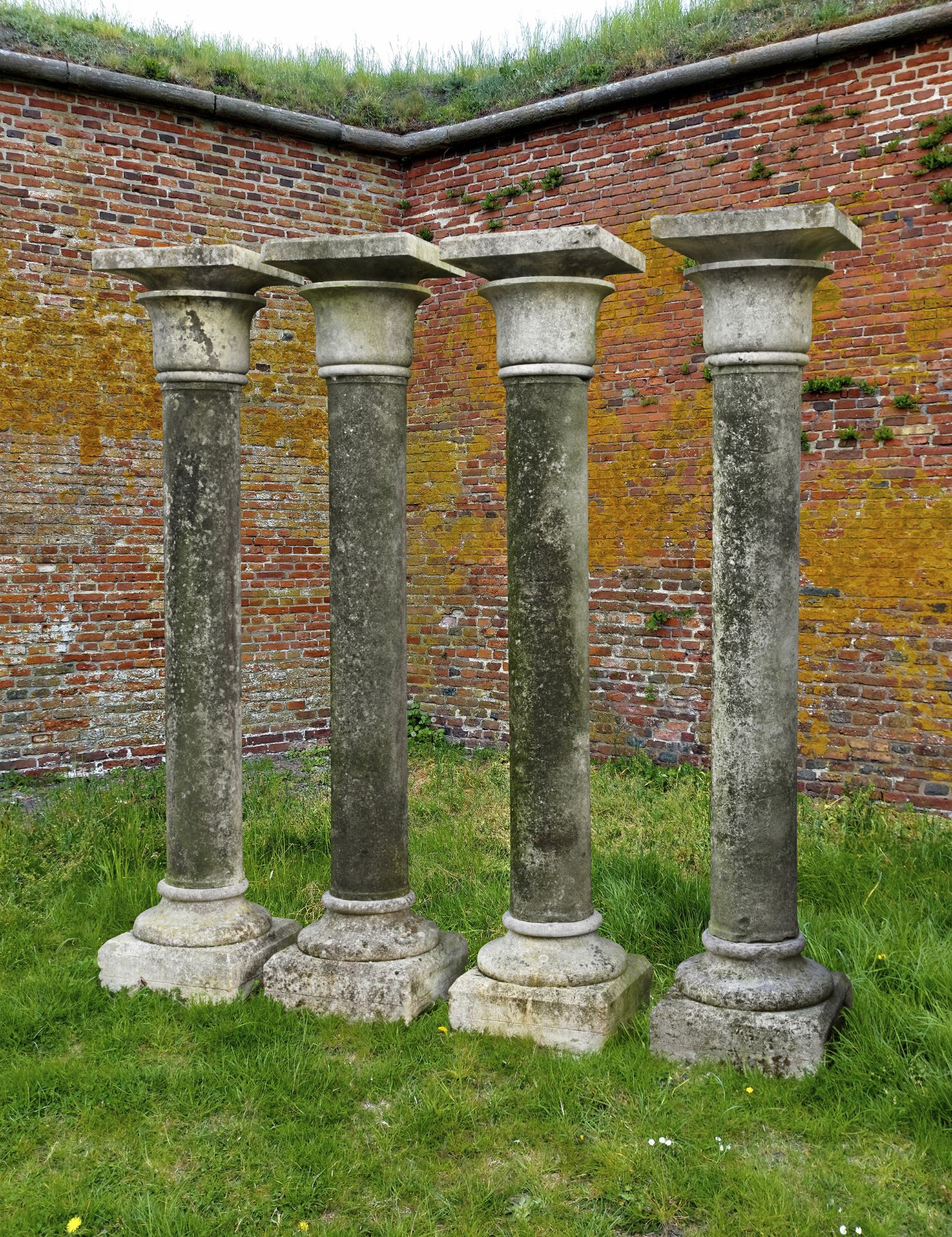 A SET OF FOUR CARVED LIMESTONE COLUMNS, 20TH CENTURY