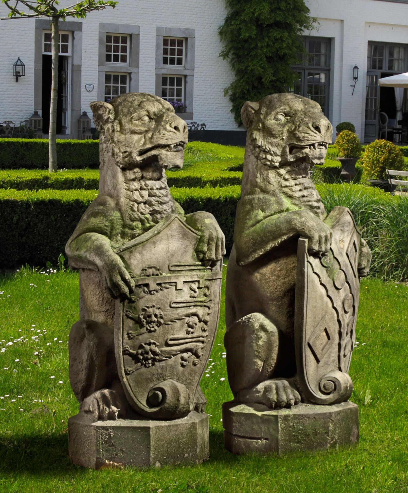 A PAIR SCULPTED SANDSTONE PIER FINIALS CARVED AS HERALDIC LIONS ALMOST CERTAINLY ENGLISH, 19TH CENTU