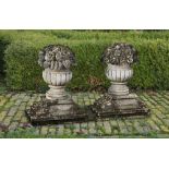 A PAIR OF CARVED LIMESTONE PIER FINIALS IN THE FORM OF FRUITING BASKETS, LATE 19TH OR EARLY 20TH CEN