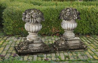 A PAIR OF CARVED LIMESTONE PIER FINIALS IN THE FORM OF FRUITING BASKETS, LATE 19TH OR EARLY 20TH CEN