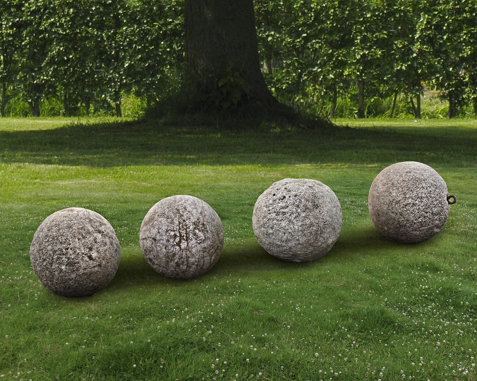 A GROUP OF FOUR STONE ORNAMENTAL SPHERES, LATE 18TH CENTURY