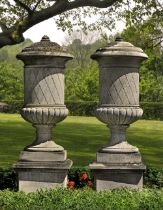 A PAIR OF SUBSTANTIAL CARVED LIMESTONE PEDESTAL URNS SECOND HALF 20TH C