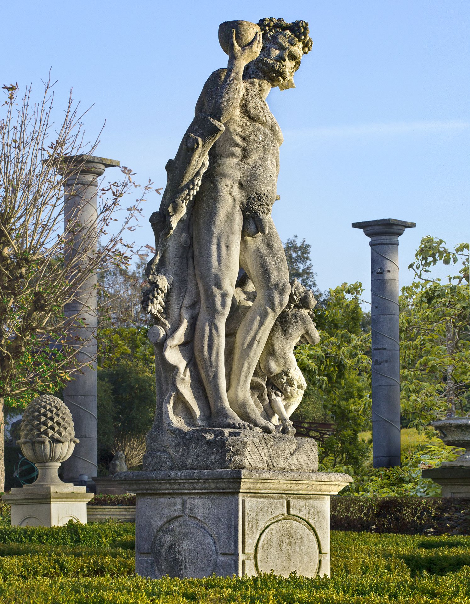 A MONUMENTAL AND IMPRESSIVE ITALIAN SCULPTED LIMESTONE GROUP OF BACCHUS WITH A SATYR, FIRST QUARTER