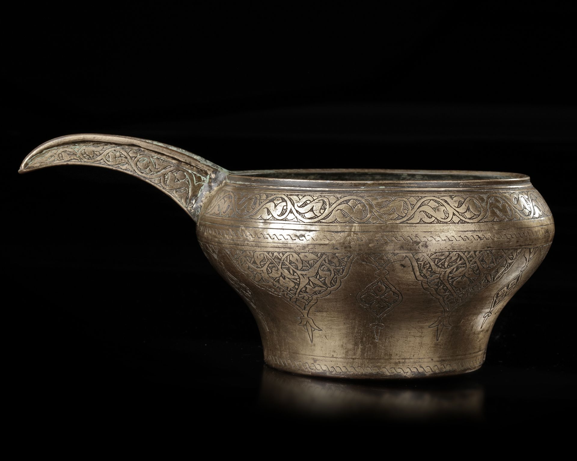 AN ENGRAVED SAFAVID TINNED COPPER SPOUTED POURING BOWL, PERSIA, 17TH CENTURY