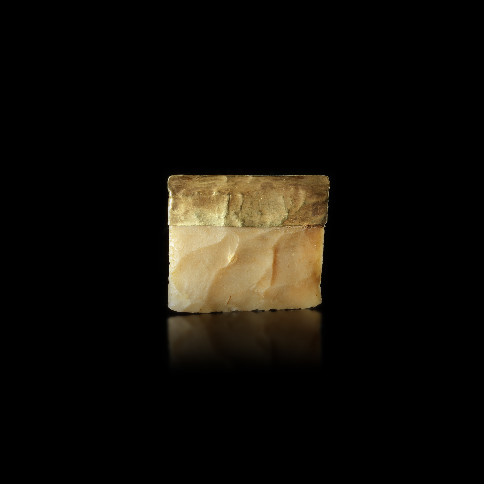 A NEAR EASTERN FLINT TOOL PARTIALLY ENCASED IN GOLD, 3RD-4TH MILLENNIUM BC