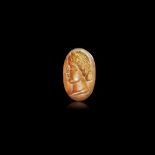 A CARNELIAN INTAGLIO IN THE ROMAN STYLE WITH A HEAD OF A WOMAN LEFT, 2ND CENTURY AD OR LATER