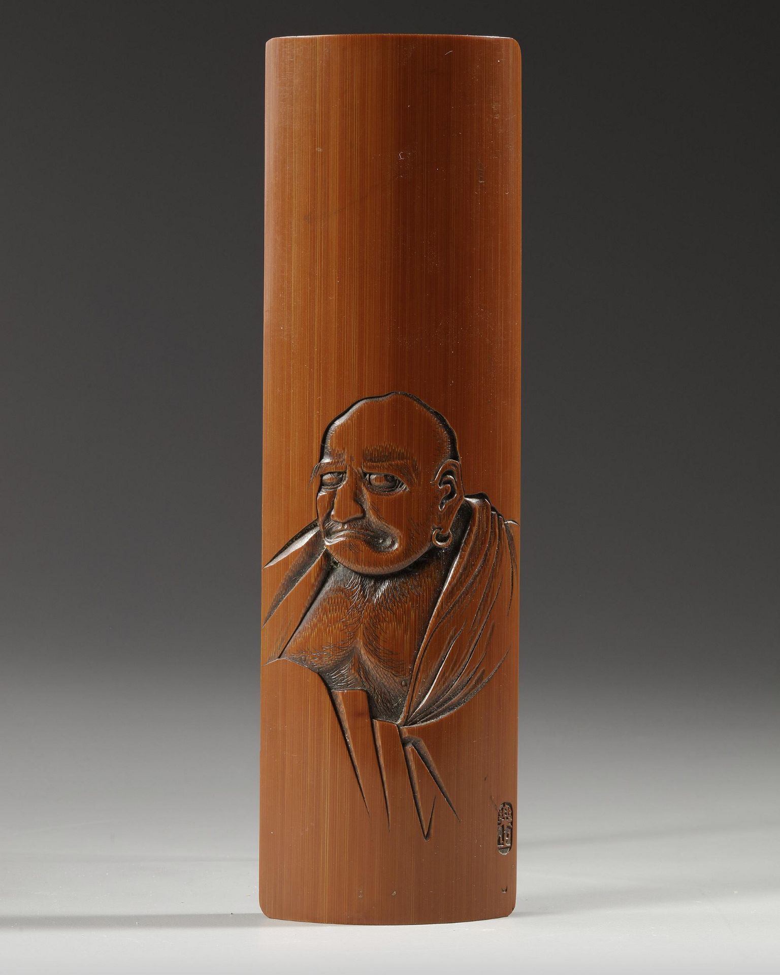 A JAPANESE BAMBOO WRIST REST DEPICTING DARU, 19TH CENTURY