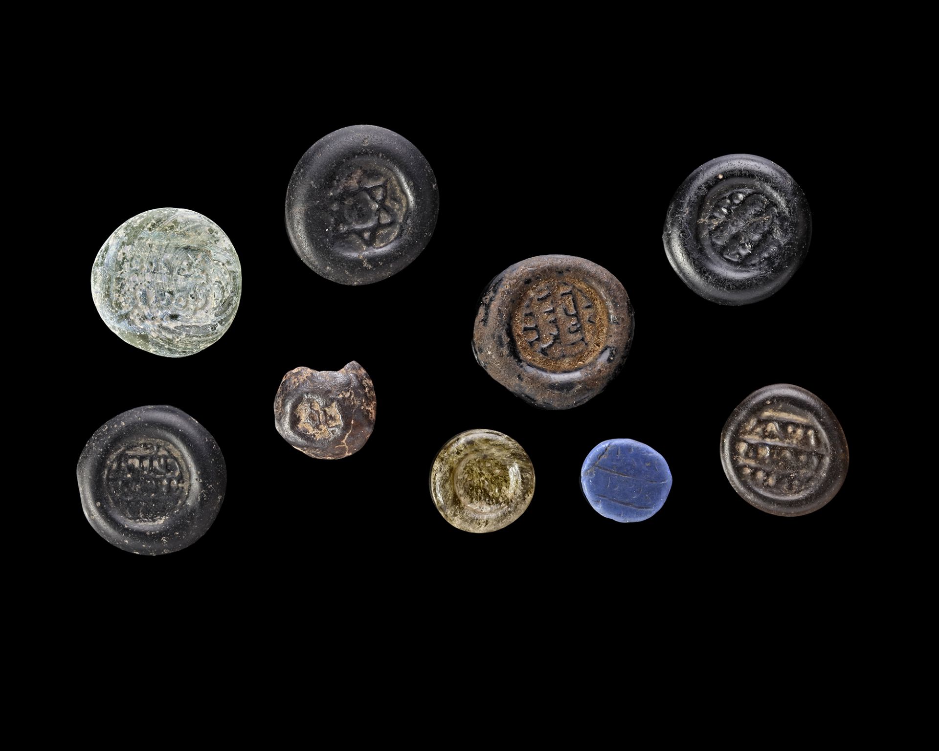 A GROUP OF NINE EARLY ISLAMIC GLASS WEIGHTS, 10TH-11TH CENTURY