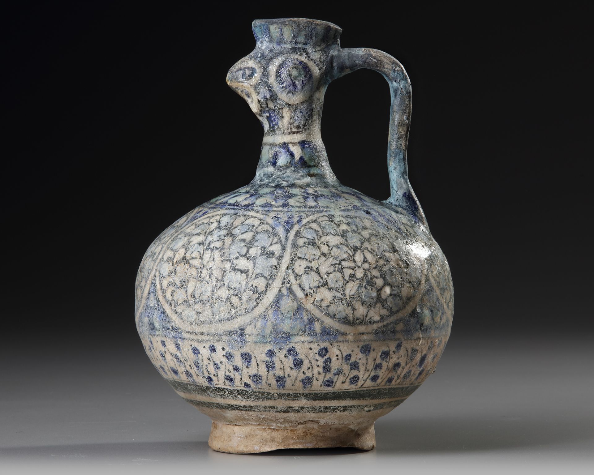 A SULTANABAD POTTERY COCKEREL-HEAD POTTERY EWER, PERSIA, 12TH CENTURY
