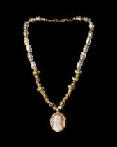 A NECKLACE WITH A CAMEO PENDANT AND NECKLACE OF ANCIENT BEADS OF VARIOUS PERIODS, 3RD CENTURY BC TO