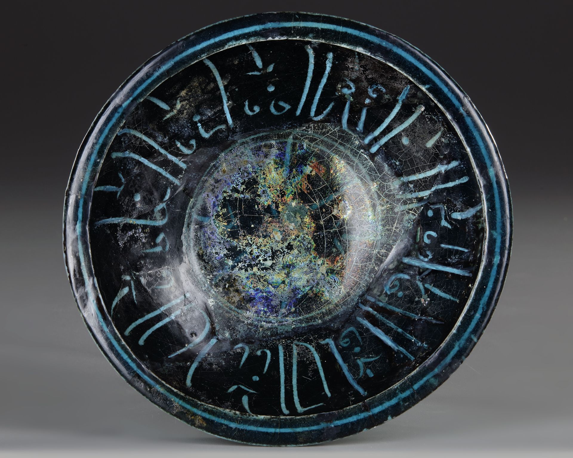 A BLACK AND TURQUOISE GLAZED KASHAN BOWL, PERSIA, 13TH CENTURY