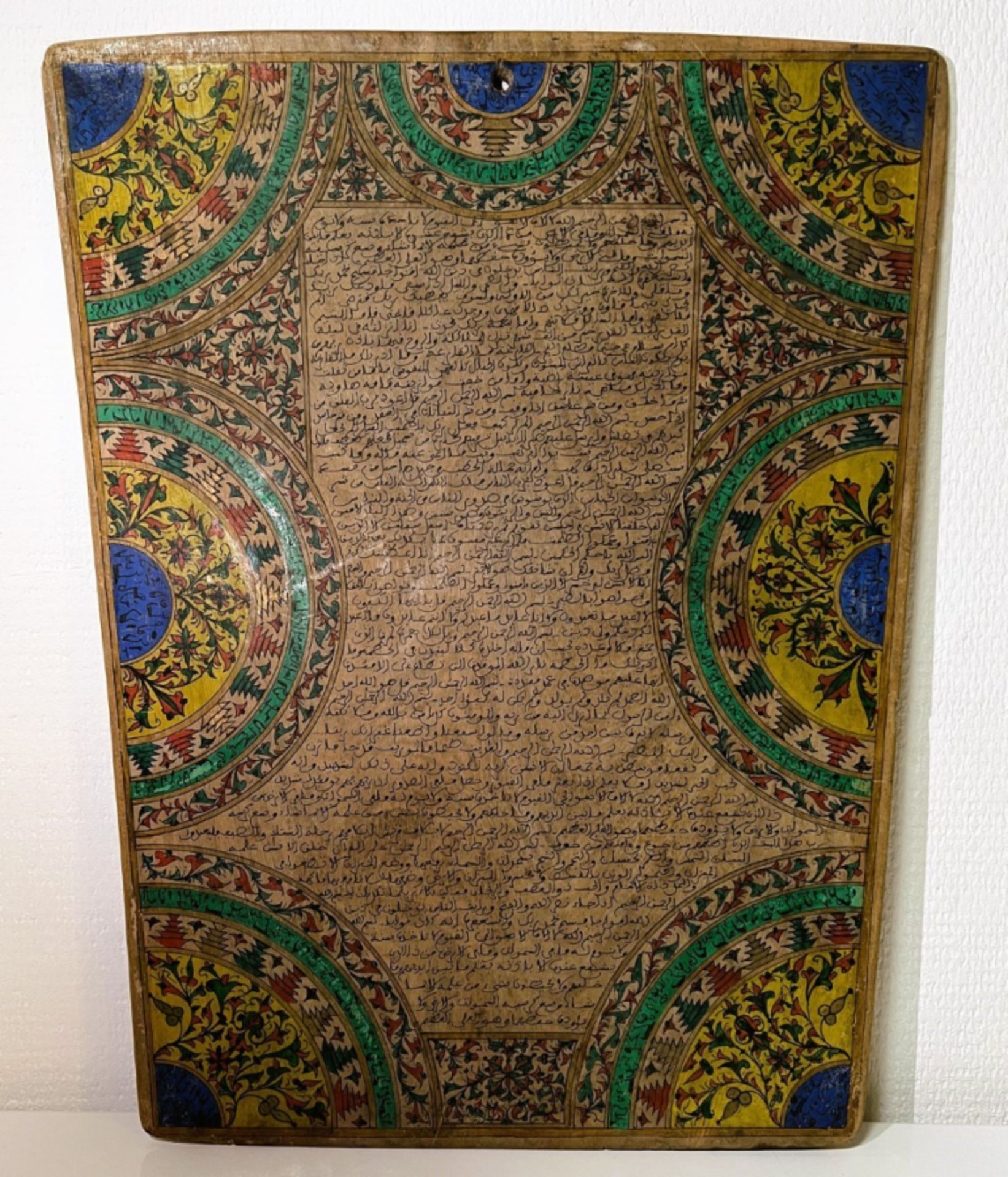 Illuminated calligraphy on wood with Quranic text