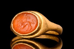 ROMAN GOLD RING WITH CARNELIAN INTAGLIO OF CUPID RIDING A LION