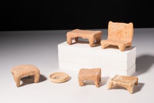 SIX GREEK TERRACOTTA MODELS OF A BED AND STOOLS