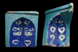 PAIR OF TUMURID GLAZED STONE NIECHES