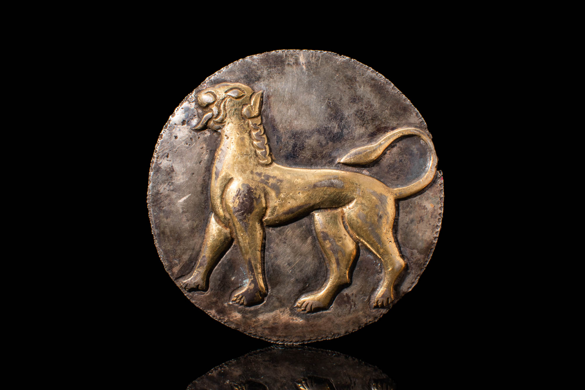 IRON AGE SILVER GILDED APPLIQUE DEPICTING A ROARING LION