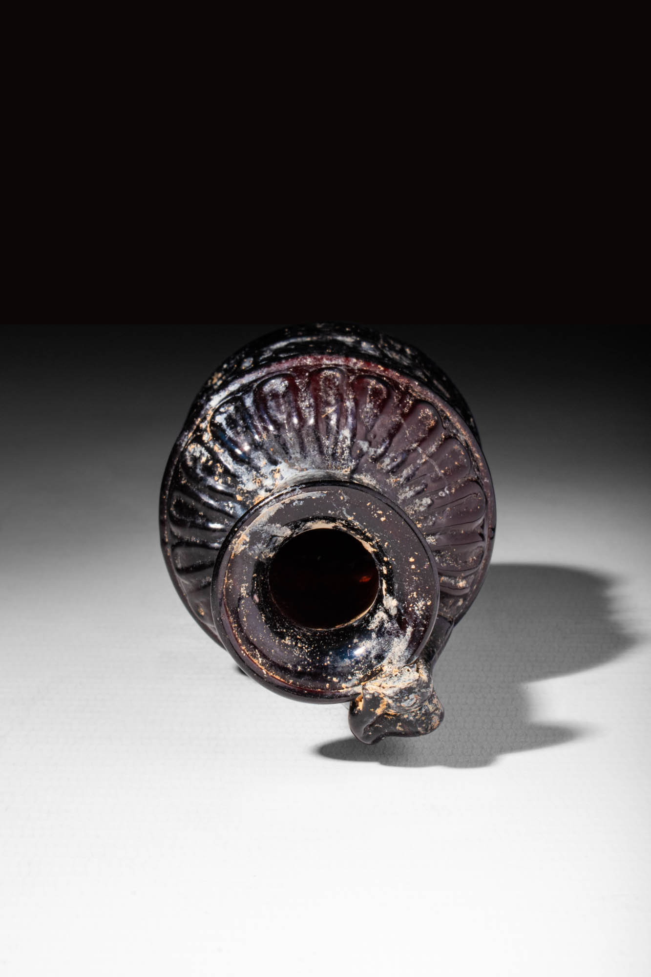 LATE ROMAN PURPLE GLASS BOTTLE DECORATED WITH MOULDED GEOMETRIC MOTIF - Image 5 of 5