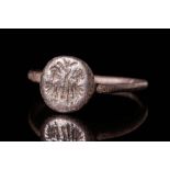 MEDIEVAL BRONZE RING WITH BEZEL DEPICTING TWO FIGURES AROUND A PALM TREE