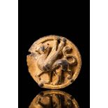 SCYTHIAN GILDED MEDALLION DEPICTING A GRIFFIN WITH INLAID EYES