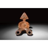 ROMAN TERRACOTTA DOUBLE OIL LAMP DECORATED WITH MOULDED MEDUSA HEAD