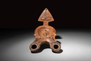 ROMAN TERRACOTTA DOUBLE OIL LAMP DECORATED WITH MOULDED MEDUSA HEAD