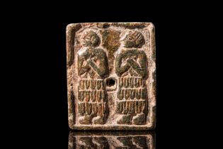 SUMERIAN STONE SEAL PLAQUE DEPICTING A DIVINE COUPLE