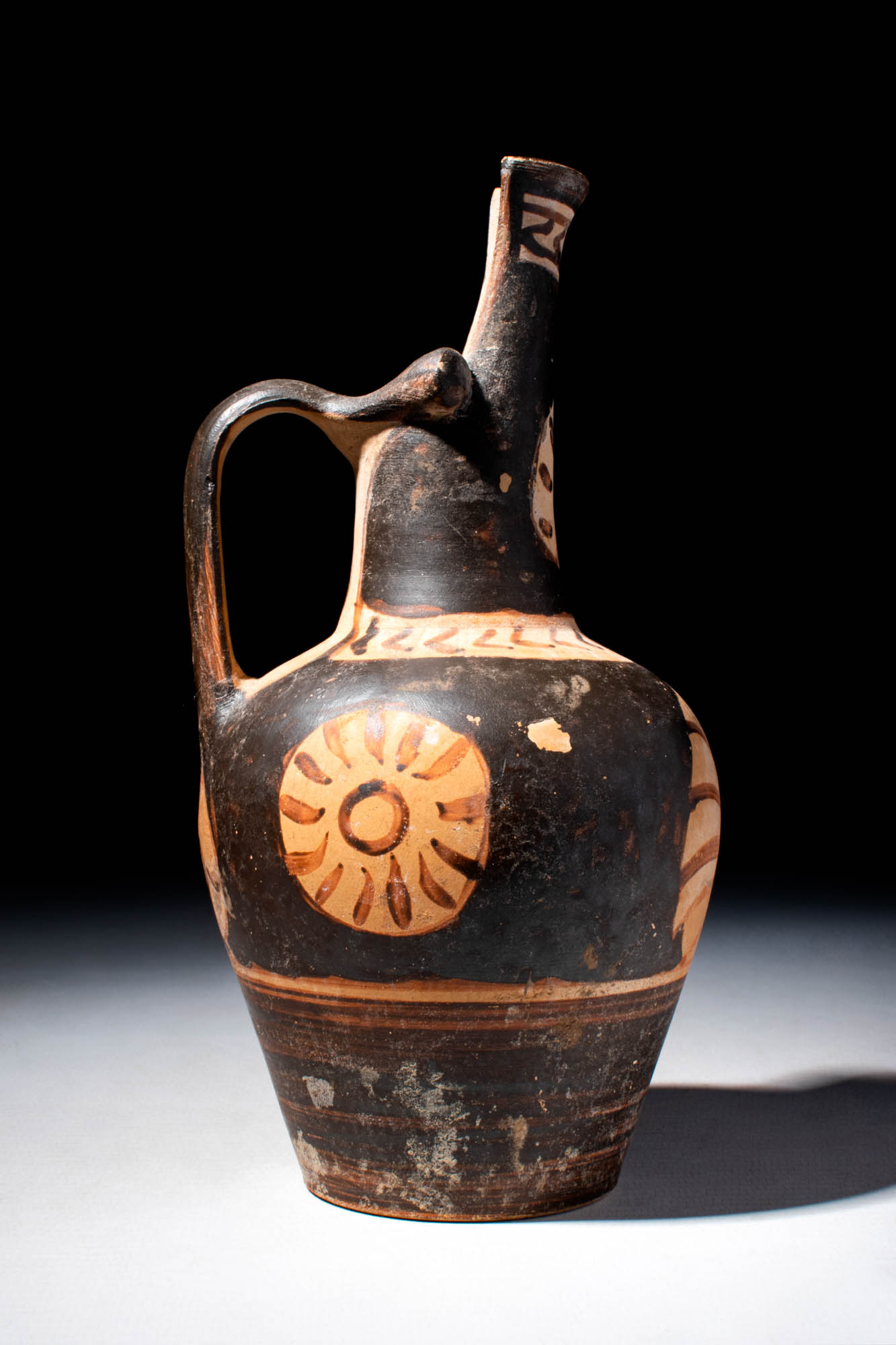 GREEK RED FIGURE EPICHYSIS DEPICTING A FLORAL MOTIF