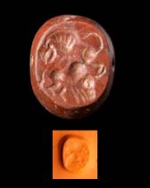 SASANIAN RED JASPER STAMP SEAL OF A LION ATTACKING A ZEBU BULL