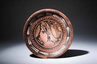 GREEK APULIAN RED-FIGURE PLATE DEPICTING THE LADY OF FASHION DRESSING SAKKOS