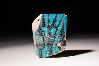 EGYPTIAN NEW KINGDOM FAIENCE PLAQUETTE DEPICTING A LOTUS FLOWER