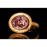 ROMAN GOLD INTAGLIO RING DEPICTING EROS RIDING HIPPOCAMPUS