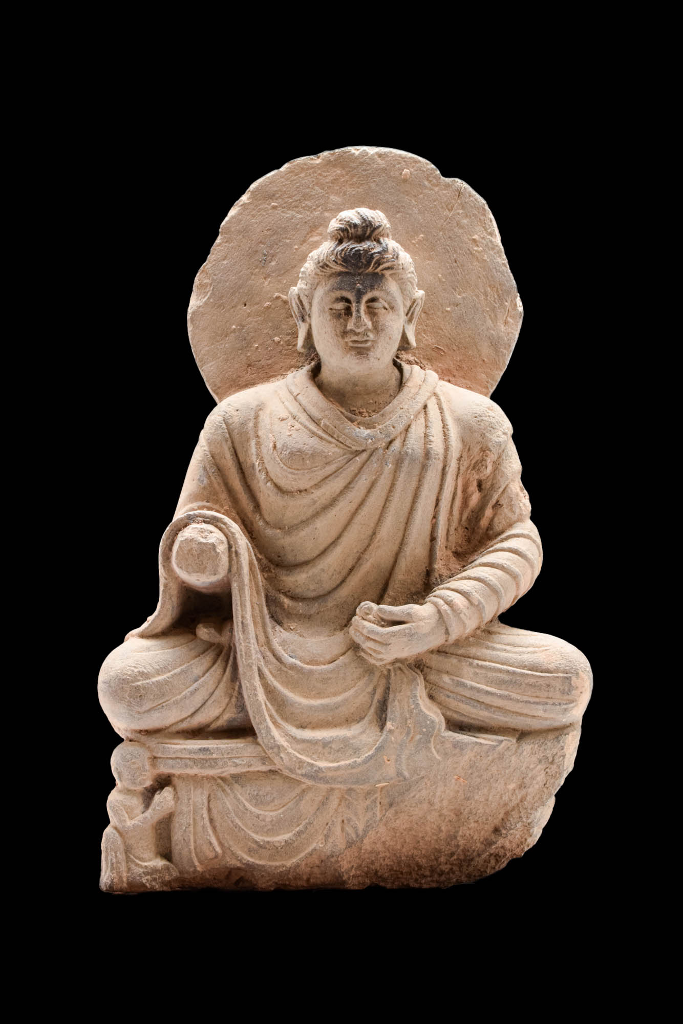 GANDHARAN GRAY SCHIST FIGURE OF A SEATED BUDDHA