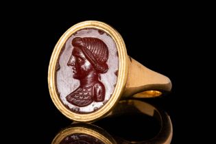 ROMAN CARNELIAN INTAGLIO DEPICTING A BUST OF WOMAN IN GOLD RING