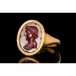 ROMAN CARNELIAN INTAGLIO DEPICTING A BUST OF WOMAN IN GOLD RING
