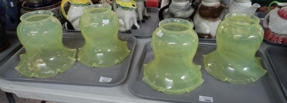 Two trays containing four early 20th Century Art Nouveau style uranium vaseline glass