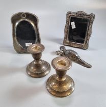 Pair of silver dwarf candlesticks with loaded bases together with two miniature silver easel picture