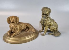 Gilt metal inkwell in the form of a recumbent Spaniel on brass moulded base, together with another