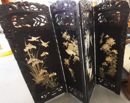 Japanese four fold stained and carved wooden screen with four lined panels of exotic birds and