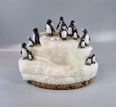 Unusual sculpture of penguins on ice made from quartz on a cork base. (B.P. 21% + VAT) Purchased