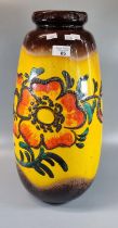 West German pottery vase decorated with flowers and foliage on a mustard and brown ground. 49cm high