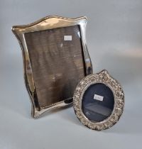 Silver Art Nouveau style easel picture frame together with another silver oval easel picture frame